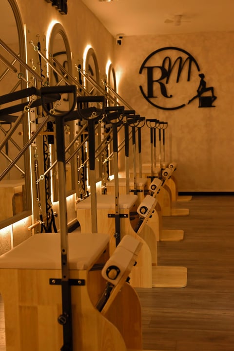 Row of wooden bikes displayed on metal racks in a warm-lit modern showroom